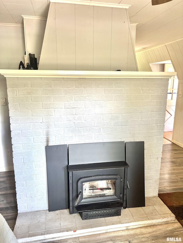 286 Kochs Ln, Meredosia, IL 62665 - detailed view of a wood stove, ornamental molding, wood finished floors, and wooden walls