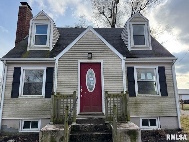 603 E Old 36th Hwy, Alexander, IL 62601 - cape cod house featuring entry steps, a chimney, and a shingled roof