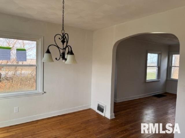 603 E Old 36th Hwy, Alexander, IL 62601 - unfurnished dining area with arched walkways, a notable chandelier, visible vents, and baseboards