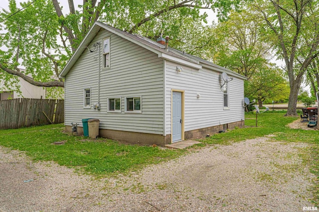 view of side of property featuring fence