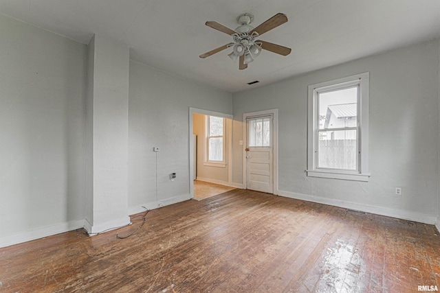 unfurnished room featuring a ceiling fan, baseboards, visible vents, and hardwood / wood-style floors