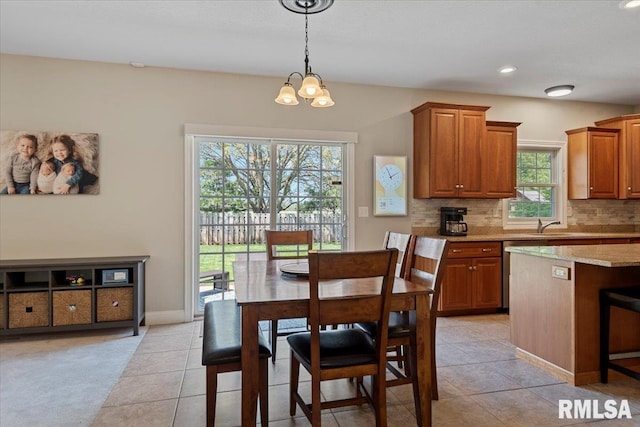 dining space with recessed lighting, baseboards, a chandelier, and light tile patterned floors