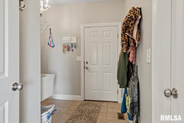 interior space featuring light tile patterned floors, baseboards, and visible vents