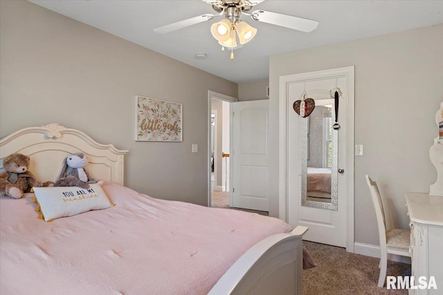carpeted bedroom featuring baseboards and a ceiling fan