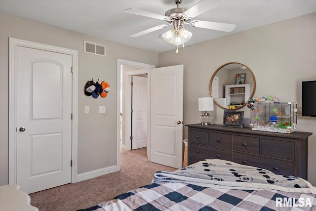 bedroom featuring visible vents, a ceiling fan, baseboards, and light carpet