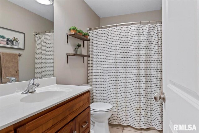 full bath featuring toilet, tile patterned floors, and vanity