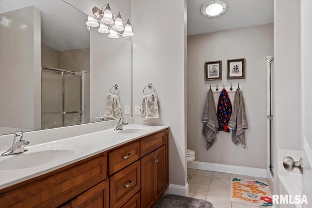 full bathroom featuring double vanity, a sink, tile patterned flooring, and a shower stall