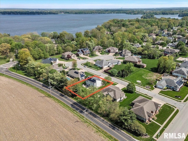 drone / aerial view with a water view and a residential view