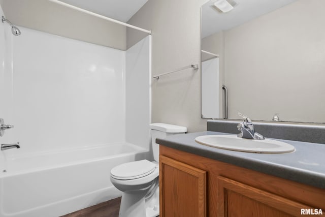 bathroom featuring toilet, visible vents, tub / shower combination, and vanity