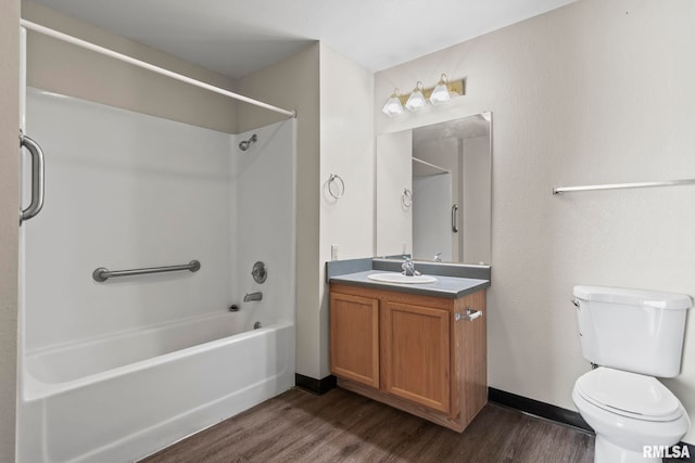 full bathroom featuring vanity, wood finished floors, toilet, baseboards, and  shower combination