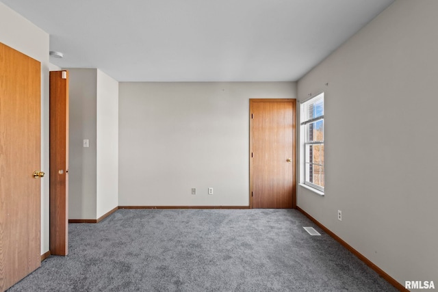 unfurnished room featuring baseboards, carpet, and visible vents