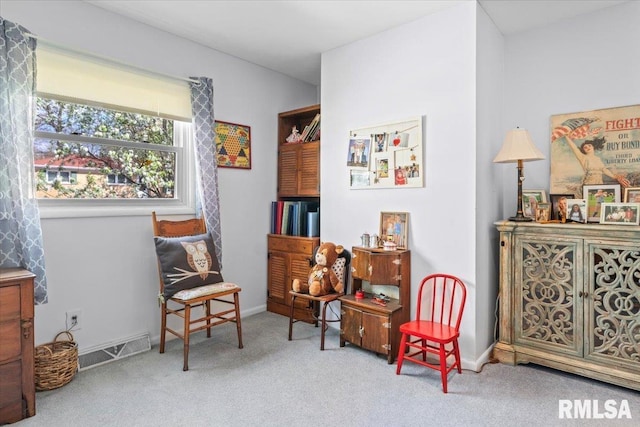 living area featuring visible vents, carpet flooring, and baseboards