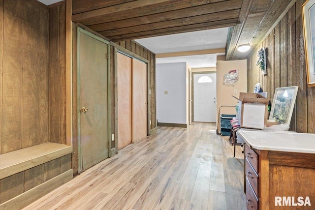 interior space featuring wooden walls and light wood-style flooring