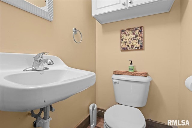 half bathroom with a sink and toilet