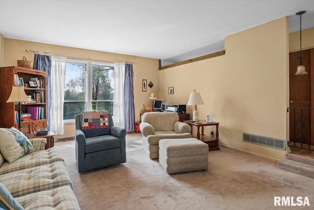 carpeted living room featuring baseboards and visible vents