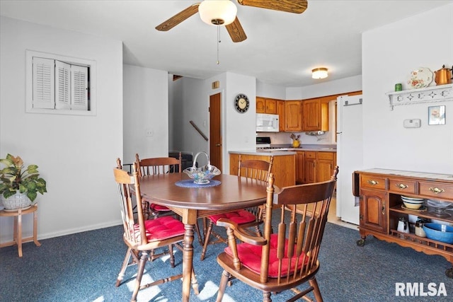 dining space with carpet floors and ceiling fan