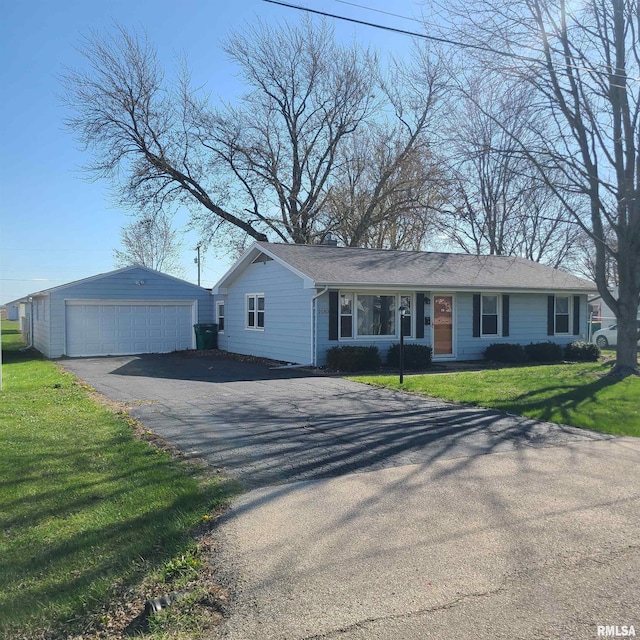 single story home with an outbuilding, a front lawn, and a garage