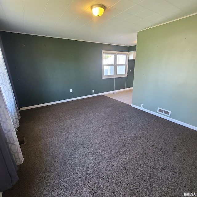 unfurnished room featuring carpet floors, baseboards, and visible vents