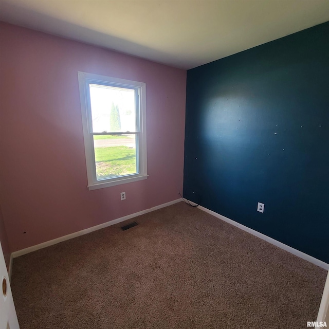 carpeted empty room with baseboards