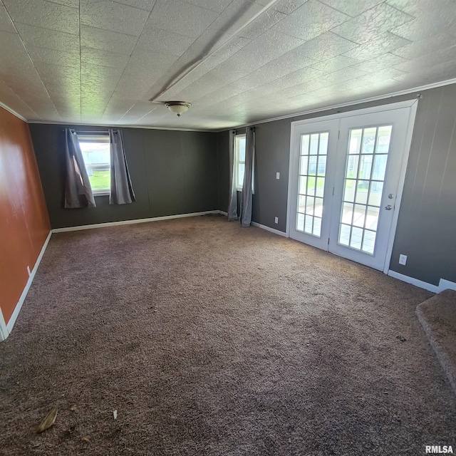 unfurnished room featuring baseboards, carpet flooring, and crown molding