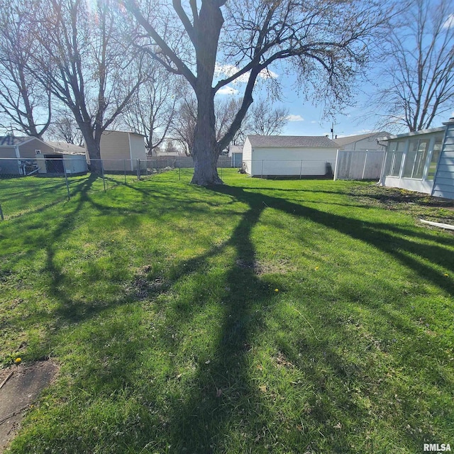 view of yard featuring a sunroom and fence