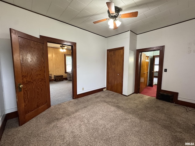 unfurnished bedroom with a ceiling fan, carpet flooring, and visible vents