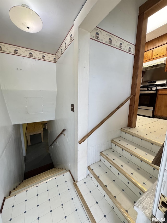 stairway with tile patterned floors