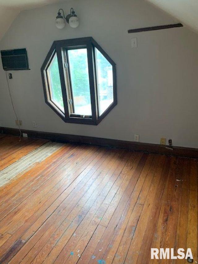 400-402 E Laurel, Springfield, IL 62704 - bonus room with lofted ceiling, hardwood / wood-style floors, a wall mounted air conditioner, and baseboards