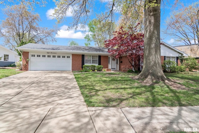 single story home featuring brick siding, an attached garage, driveway, and a front yard
