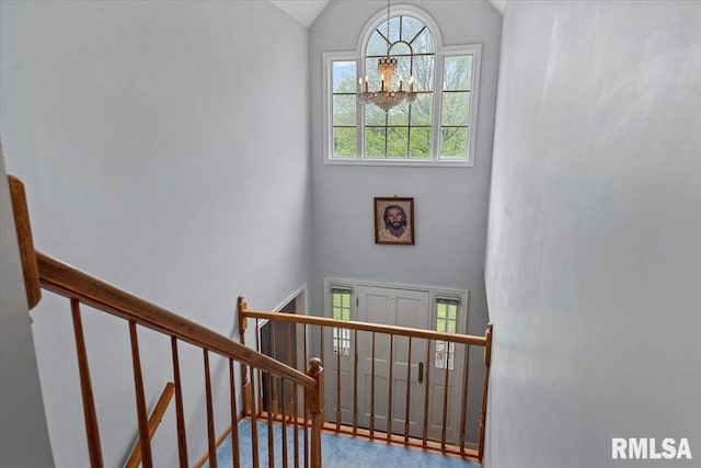 3300 Winch Rd, Springfield, IL 62707 - staircase featuring a chandelier, plenty of natural light, carpet flooring, and high vaulted ceiling