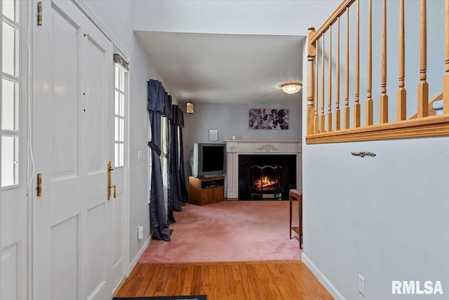 3300 Winch Rd, Springfield, IL 62707 - foyer featuring a warm lit fireplace, baseboards, and wood finished floors