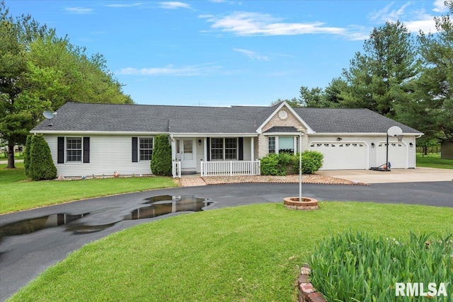ranch-style home featuring covered porch, a front yard, roof with shingles, an attached garage, and driveway