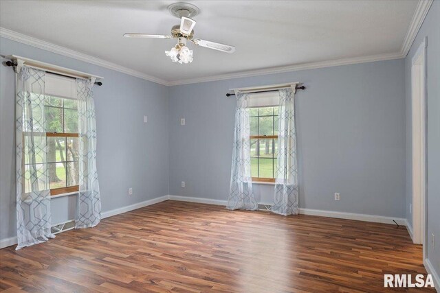 spare room with ceiling fan, visible vents, ornamental molding, and wood finished floors