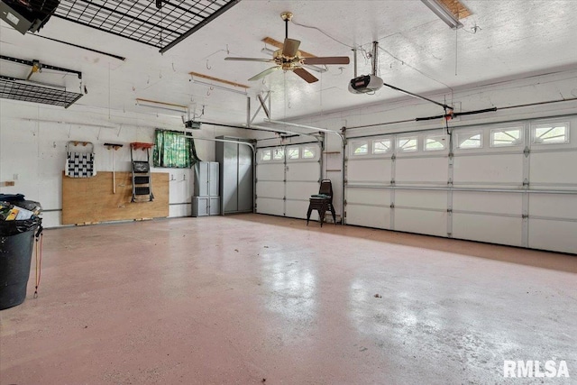 garage featuring ceiling fan, a garage door opener, and freestanding refrigerator
