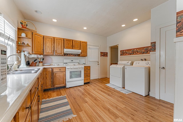 kitchen featuring open shelves, washer and dryer, gas range gas stove, light countertops, and a sink