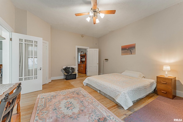 bedroom with baseboards, ceiling fan, and light wood finished floors