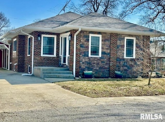 view of front of house with concrete driveway, brick siding, and roof with shingles