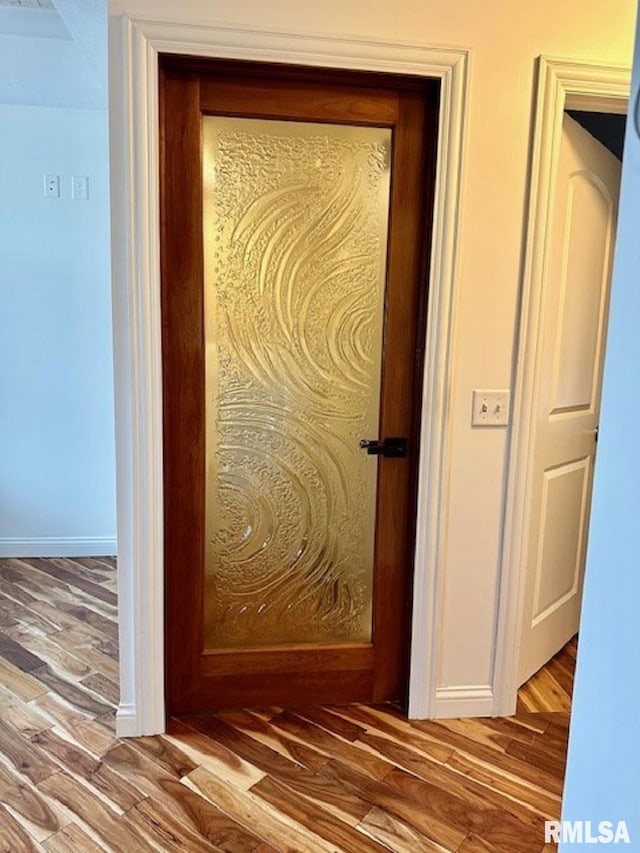 details featuring baseboards and wood finished floors