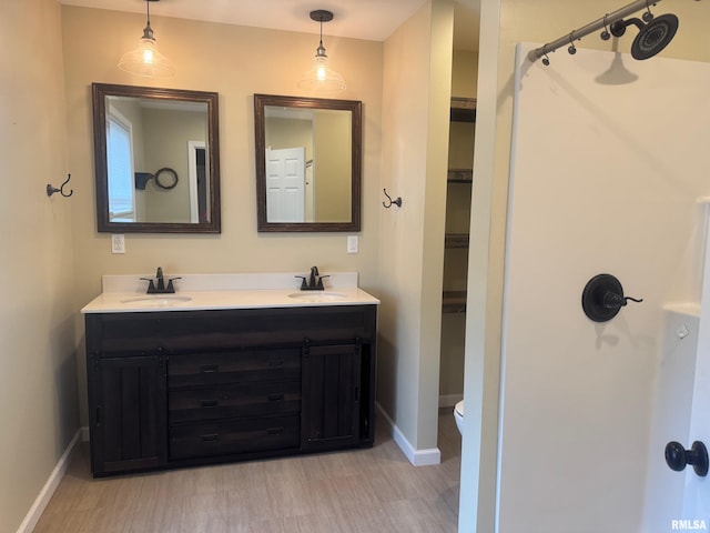 912 N Main St, Monroe City, MO 63456 - full bathroom featuring baseboards, a sink, and wood finished floors