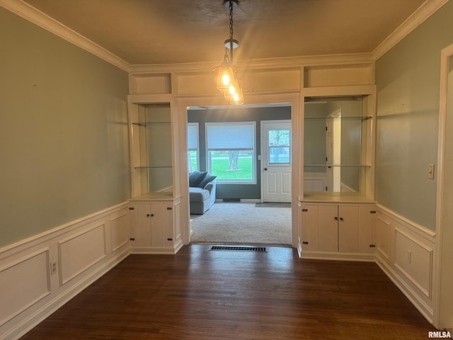 912 N Main St, Monroe City, MO 63456 - unfurnished dining area with ornamental molding, dark wood finished floors, a decorative wall, and a wainscoted wall