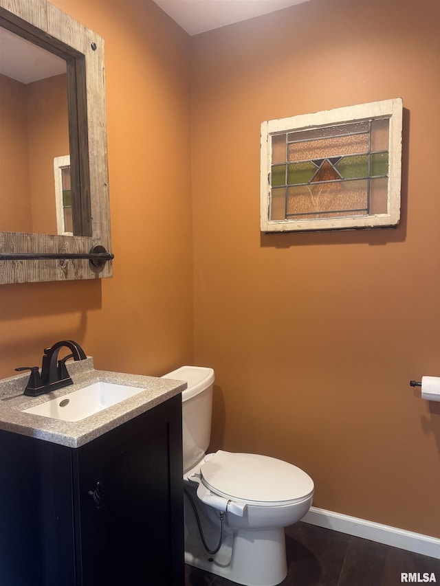 912 N Main St, Monroe City, MO 63456 - bathroom featuring vanity, baseboards, tile patterned floors, and toilet