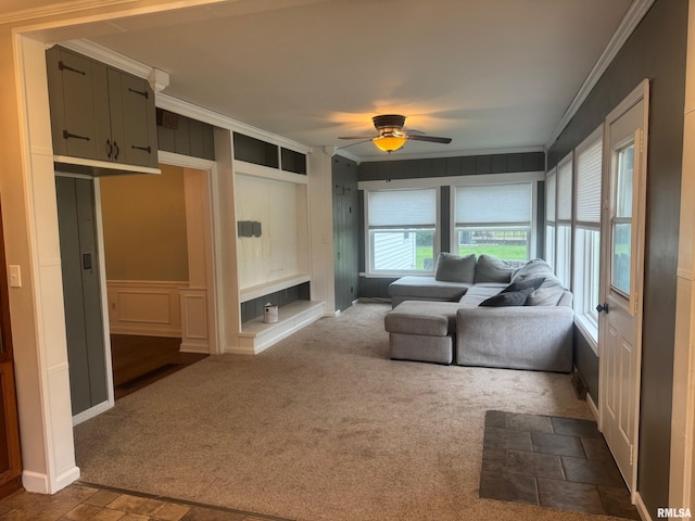 912 N Main St, Monroe City, MO 63456 - living room featuring dark carpet, ornamental molding, a ceiling fan, and a decorative wall