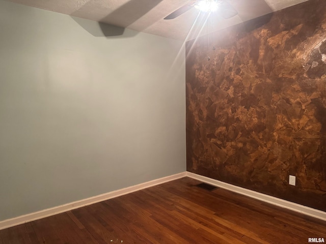912 N Main St, Monroe City, MO 63456 - spare room featuring a ceiling fan, baseboards, vaulted ceiling, and dark wood-type flooring