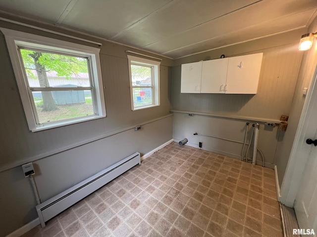 laundry room featuring baseboards, a baseboard radiator, cabinet space, and hookup for a washing machine