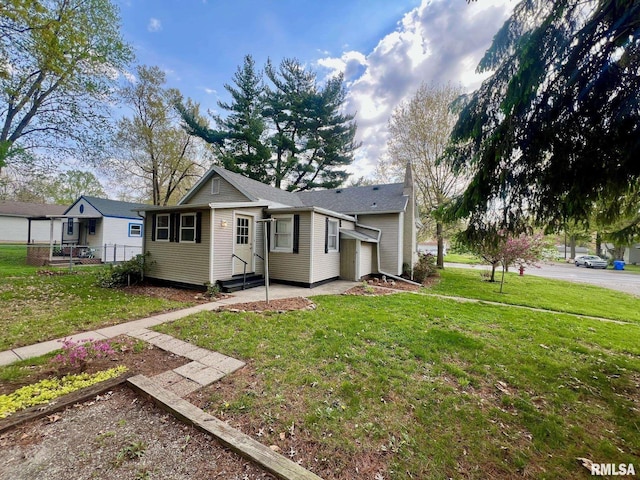 view of front of property with entry steps, fence, and a front yard