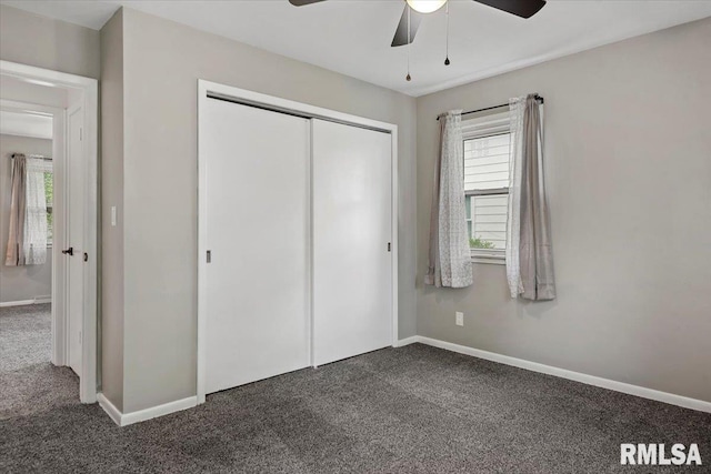 unfurnished bedroom featuring a closet, carpet, and multiple windows