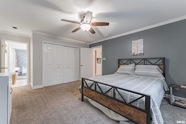 bedroom with a closet, ornamental molding, baseboards, ceiling fan, and light colored carpet