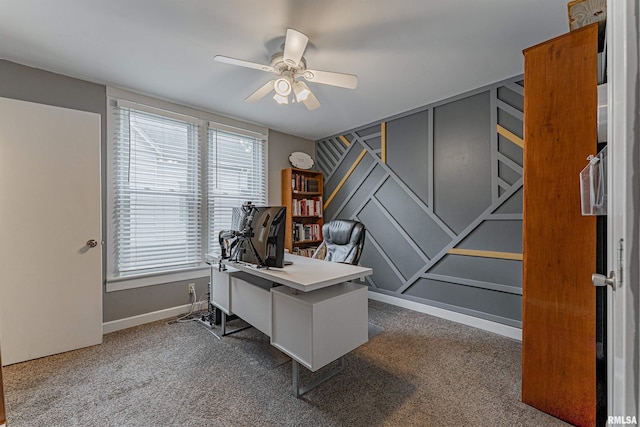 carpeted office space featuring baseboards, plenty of natural light, and a ceiling fan