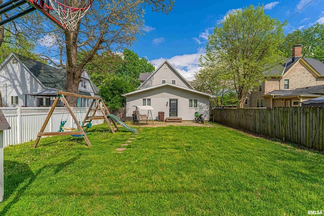 back of property featuring a fenced backyard, a playground, and a yard
