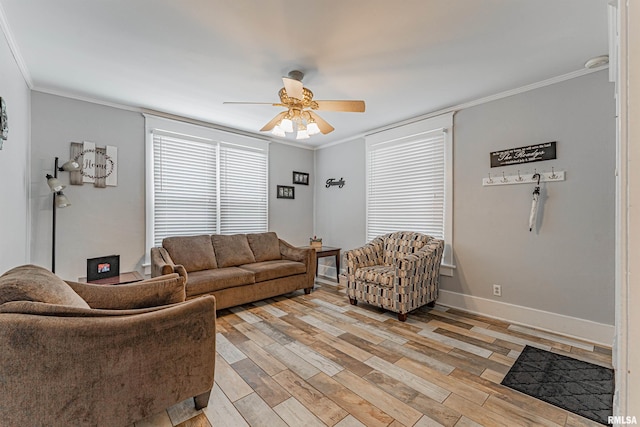 living room featuring light wood-style floors, ornamental molding, and a ceiling fan